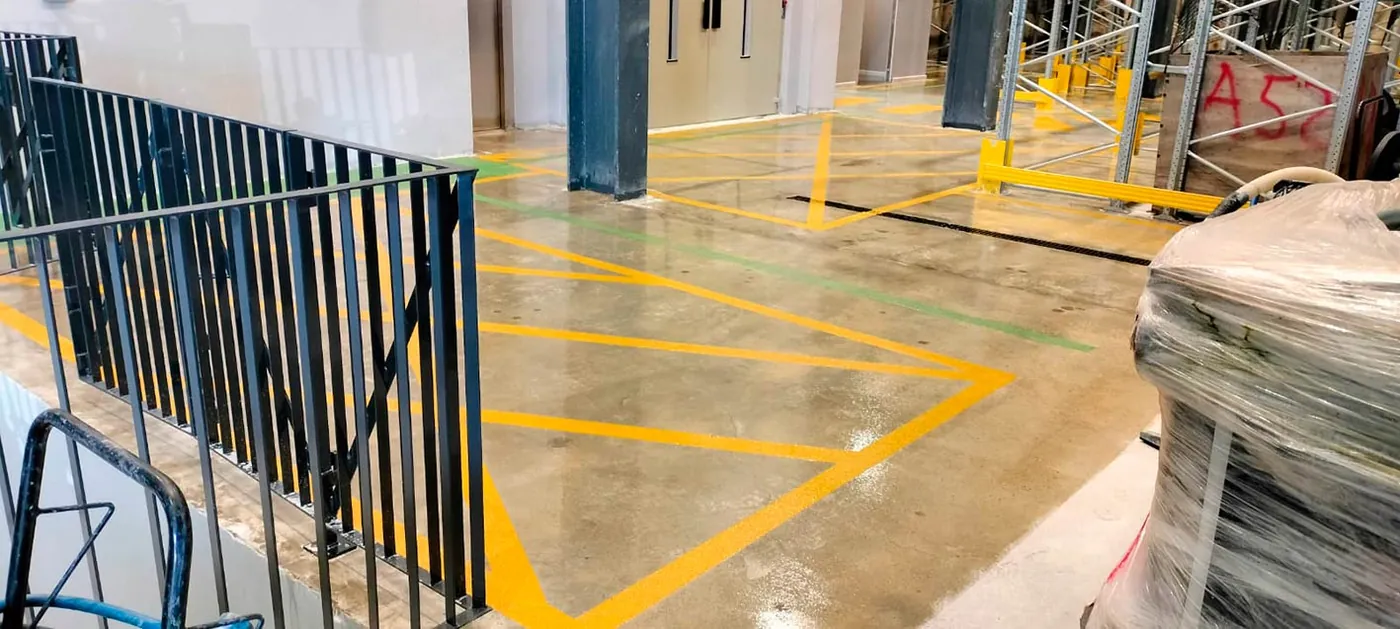 Yellow line markings on a sealed warehouse floor in Malta