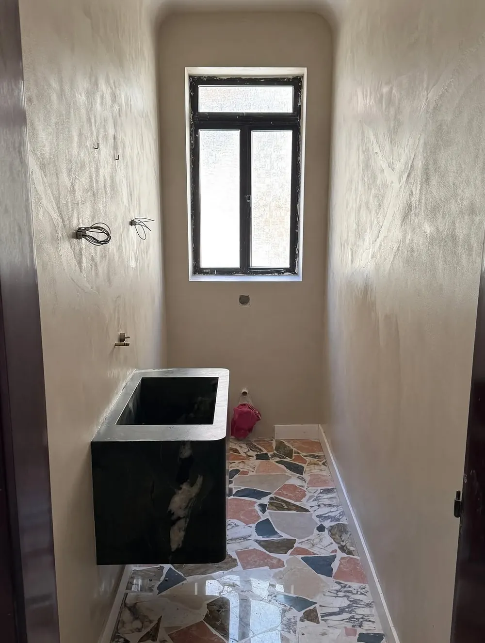 Microcement bathroom walls with terrazzo floor in Malta
